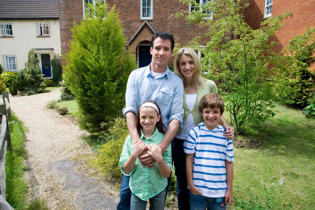 Family standing outside their home protected by residential security systems